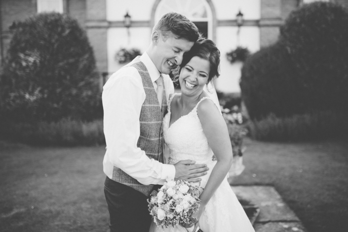 Happy couple embracing on their wedding day