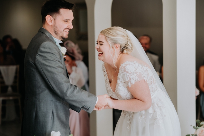 Bride and groom sharing joyful wedding moment