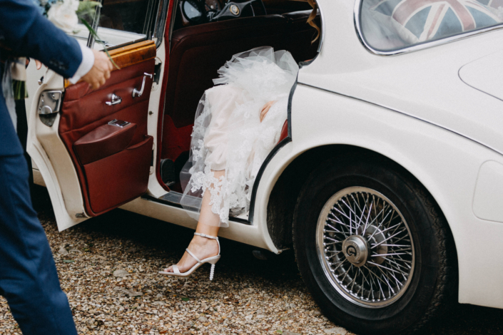 Bride stepping out of a classic car
