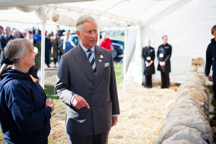 Man in suit visiting event under marquee tent