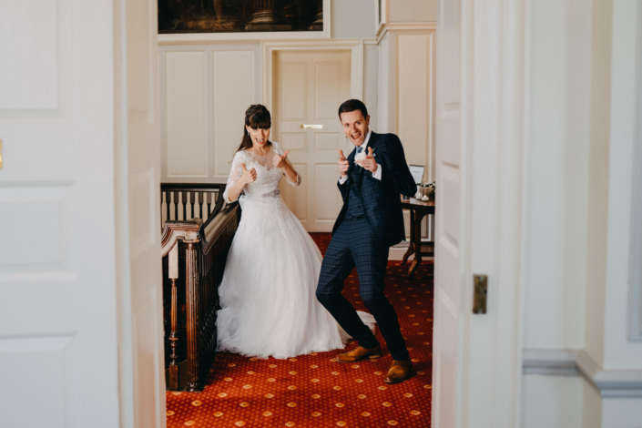 Happy couple posing playfully on wedding day