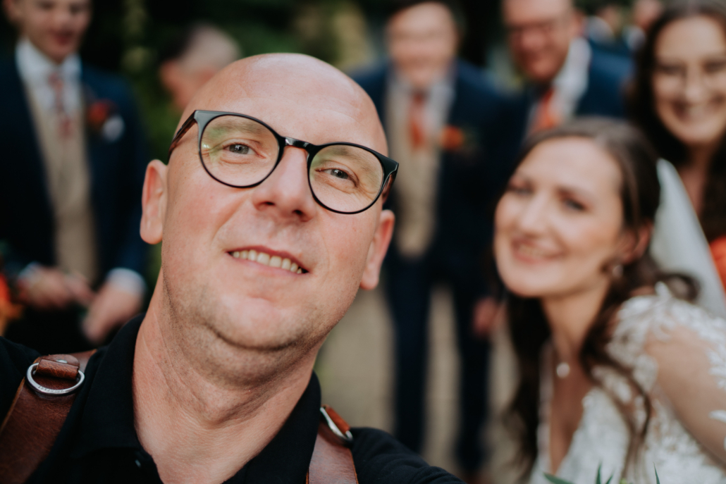 Wedding photographer Peter Oliver takes selfie with happy couple