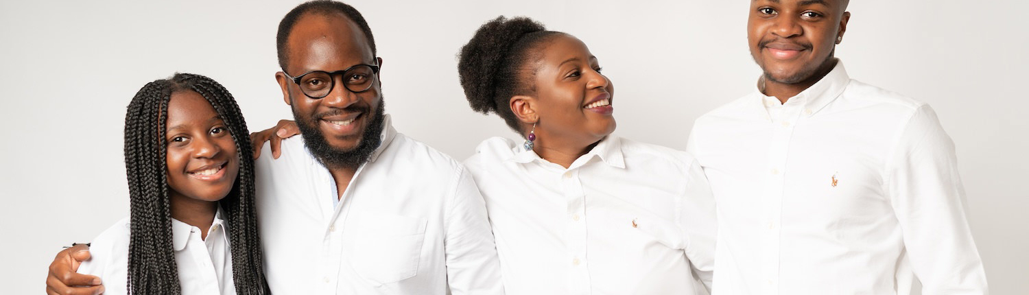 Family smiling together in white matching outfits