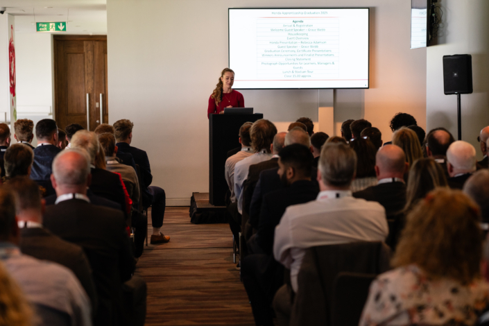 Speaker presenting at business conference with audience