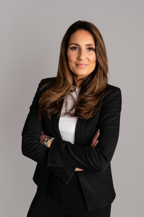 Professional woman in business attire smiling confidently