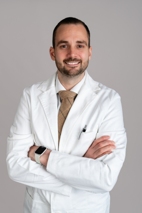 Confident doctor in white coat smiling confidently