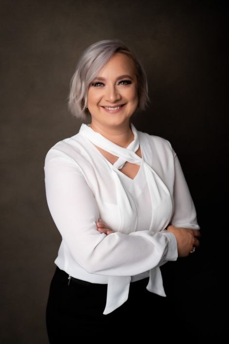 Smiling woman in professional white blouse portrait