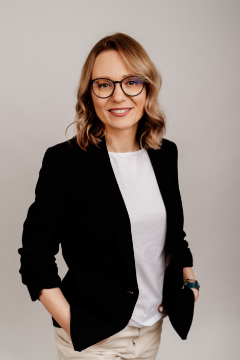 Professional woman in glasses wearing black blazer