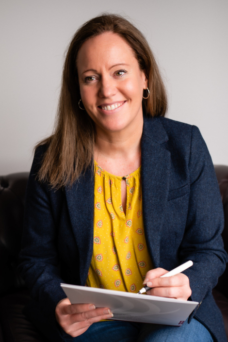 Smiling woman holding tablet in office setting