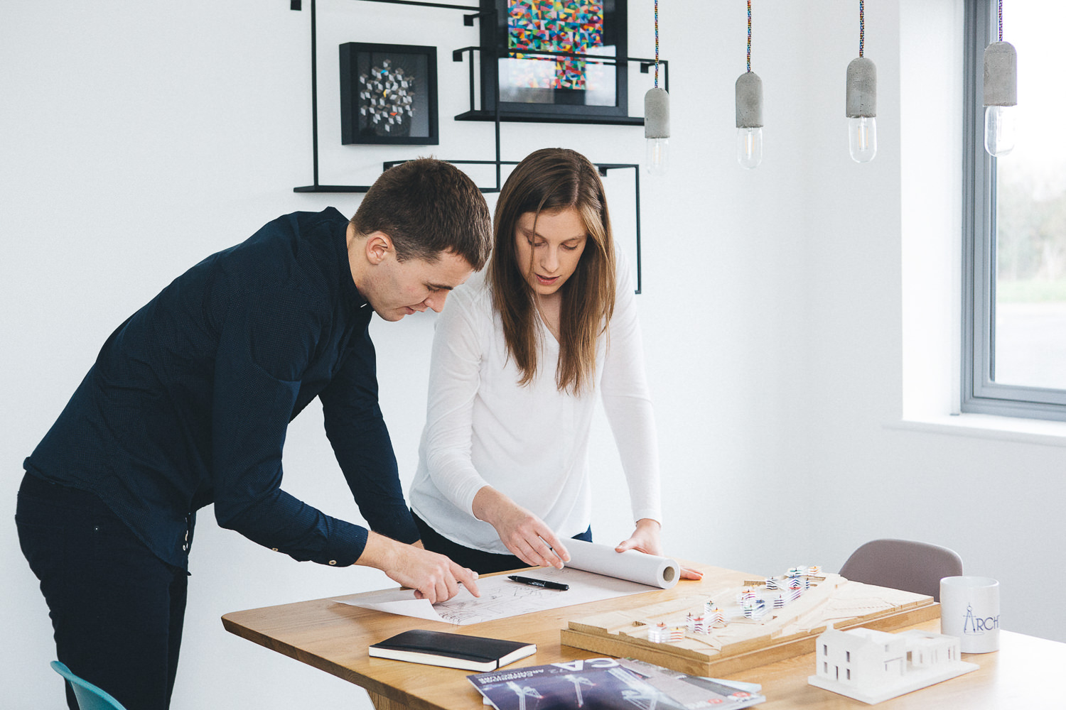Architects reviewing blueprints in modern office setting