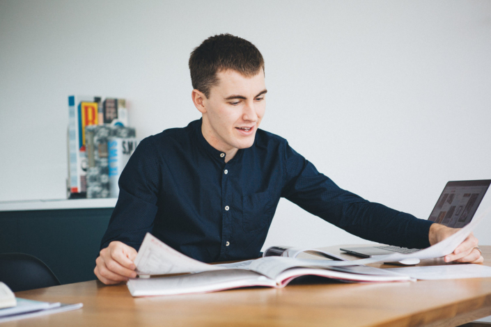 Man studying at desk with open books