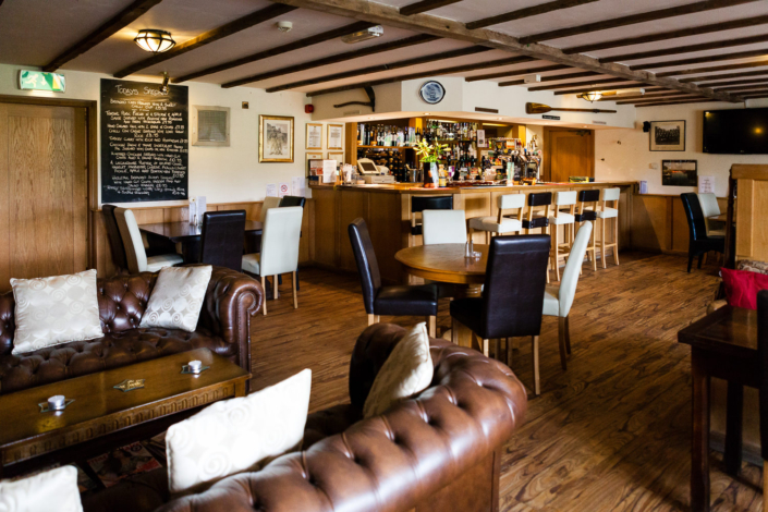 Cozy pub interior with wooden floor and bar