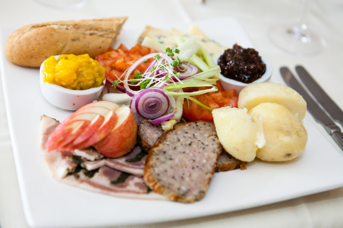 Assorted cold meats and cheeses on plate