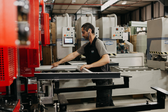 Factory worker operating machinery in industrial setting