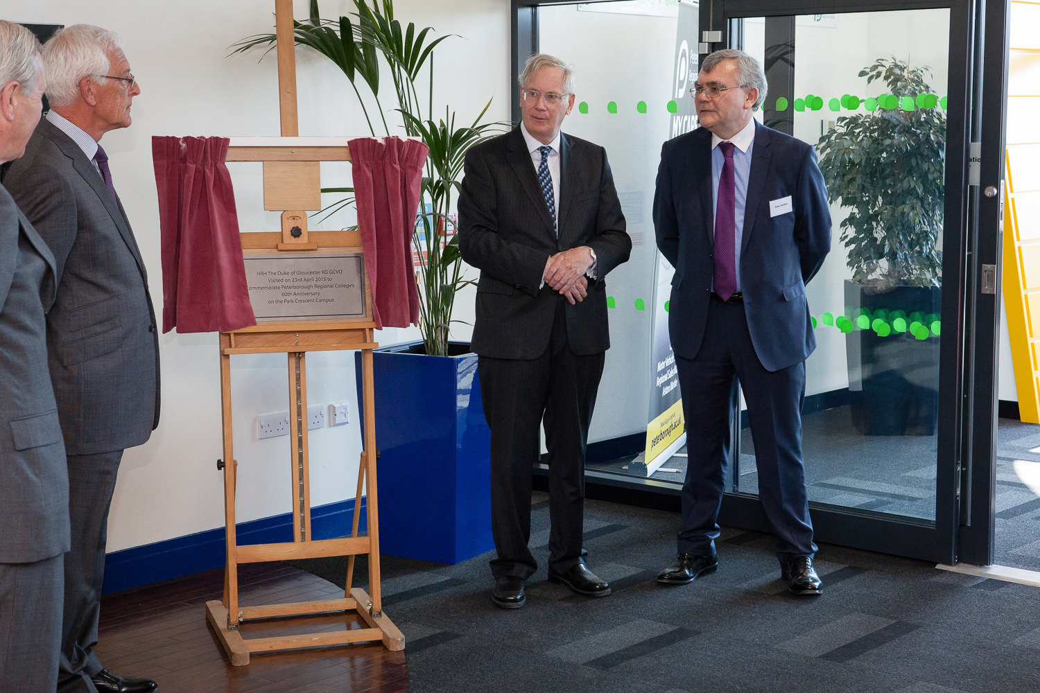 Formal event unveiling with people in suits