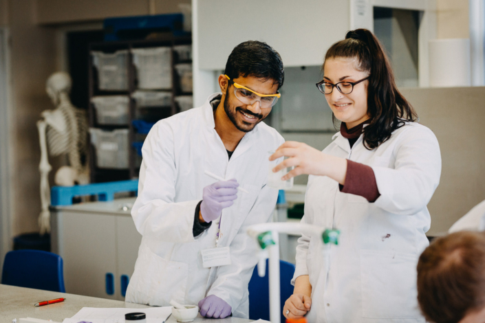 Students conducting experiment in laboratory class together