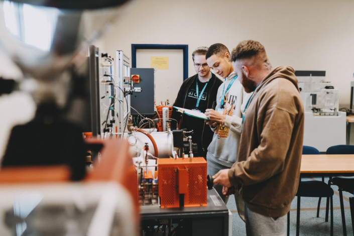 Students working in a laboratory with equipment.