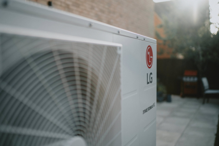 Outdoor air conditioner unit on sunny patio