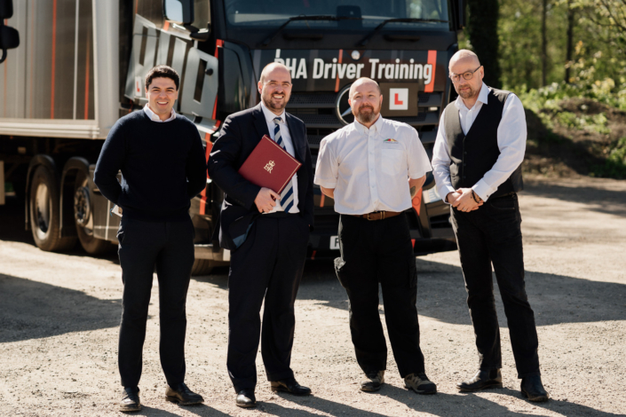 Group of men in front of truck