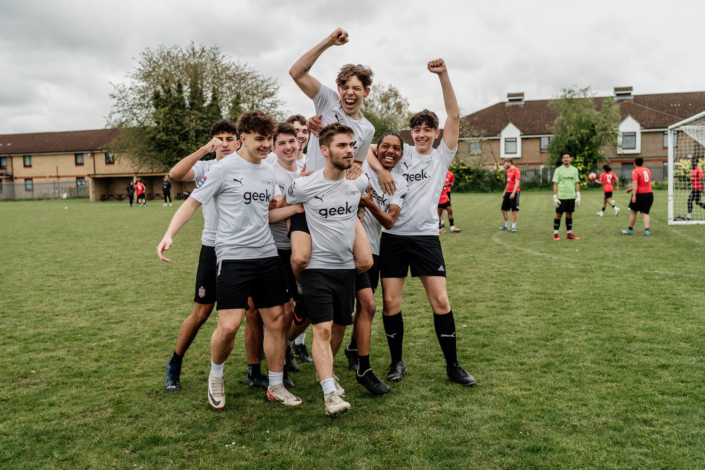 Celebrating football team on the field happily