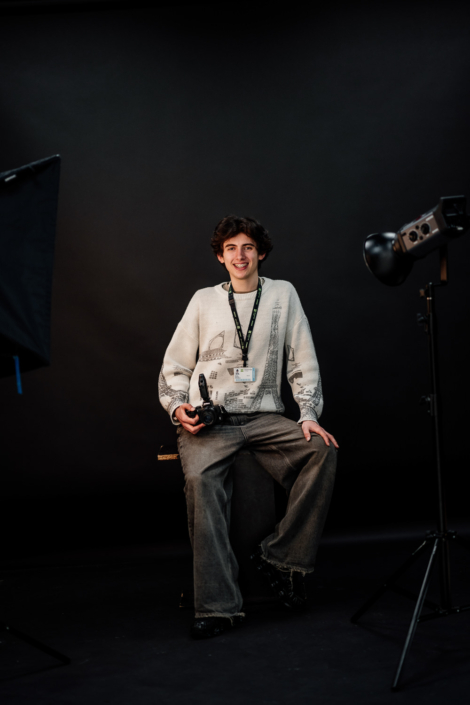 Photographer in studio with camera and equipment