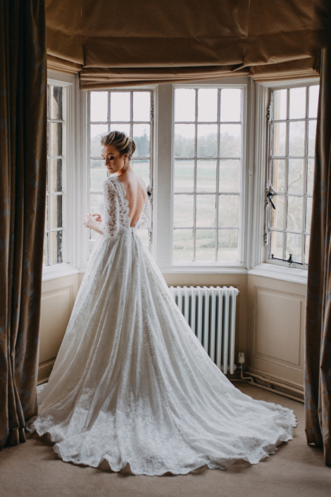 Bride in elegant lace wedding dress indoors