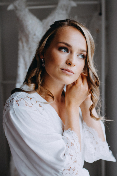 Bride preparing for wedding day with earring