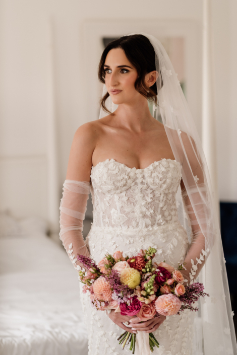 Bride in elegant wedding dress holding flowers